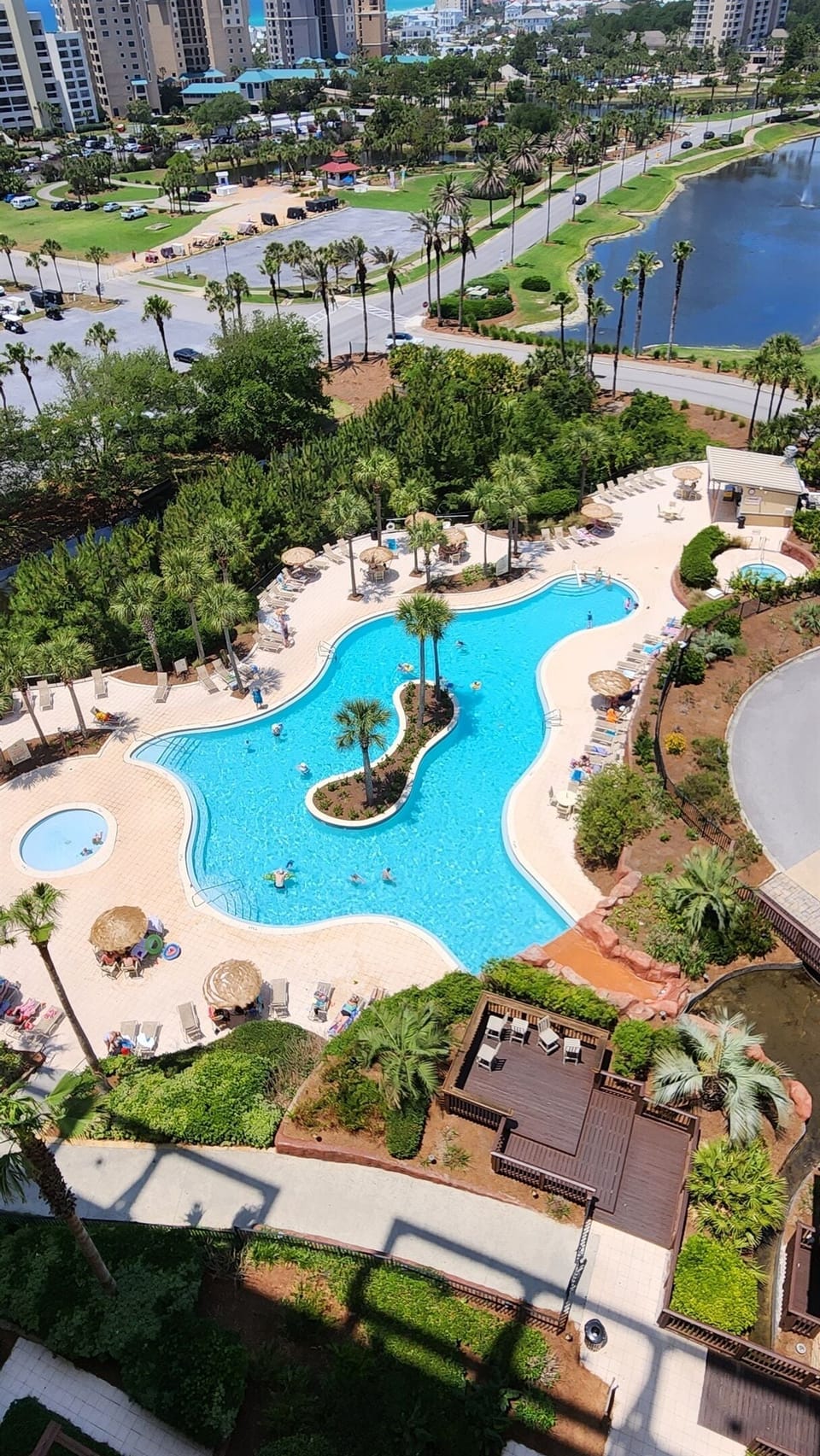 View showing: Kiddie pool, large resort pool and hot tub at the other end of the pool near the bar/food kiosk