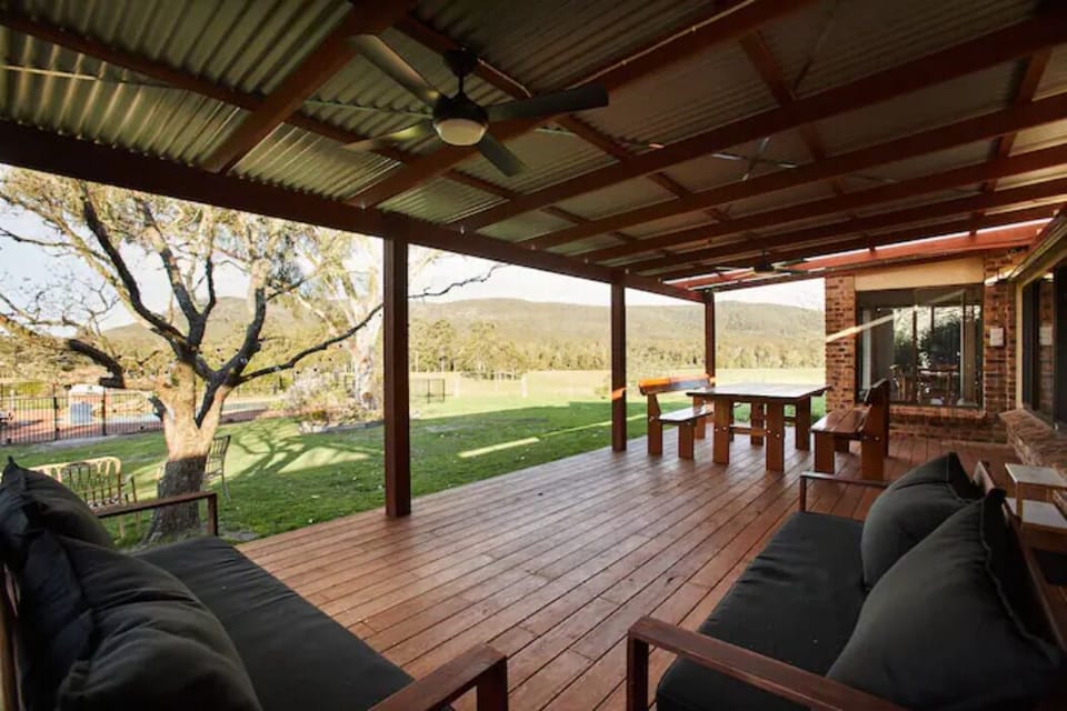 Large outdoor deck with dining setting and lounges.