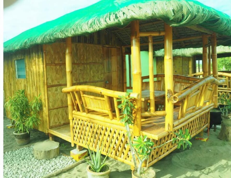 Local style cottage with a veranda in a garden setting.