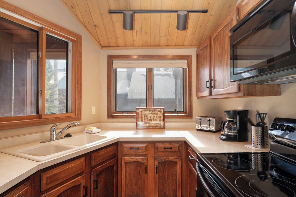 Your fully equipped kitchen awaits with warm wood finishes, modern appliances, and everything needed to craft memorable meals during your stay.