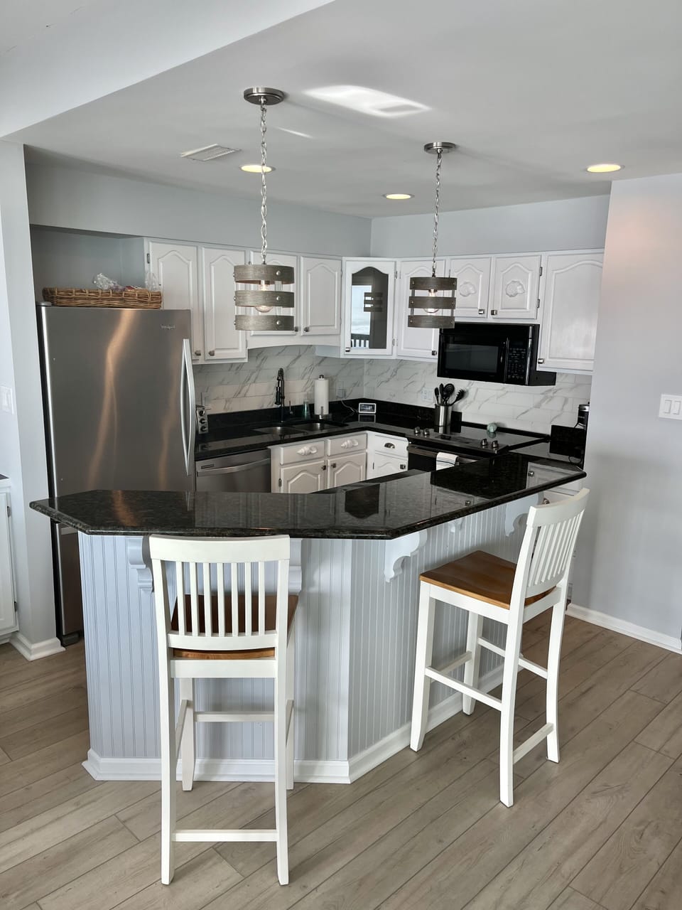 Kitchen with counter seating. 