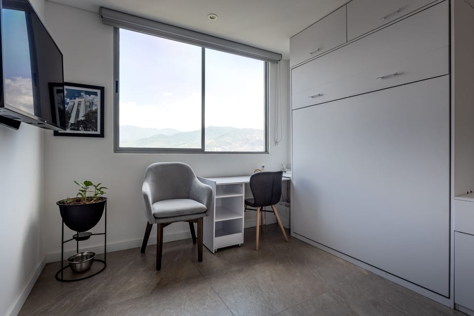 Office area in second bedroom, A/C, TV, murphy bed is out of sight.