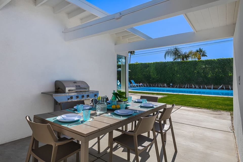 Outdoor dining for up to 8 guests in covered breezeway with gas BBQ