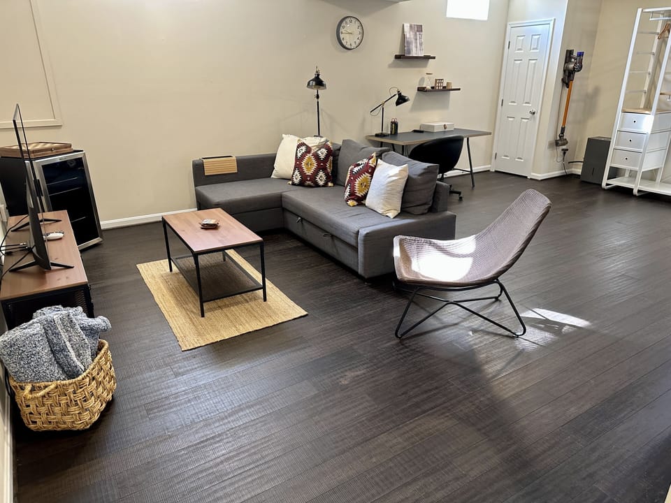 Basement living room and work space/desk area.