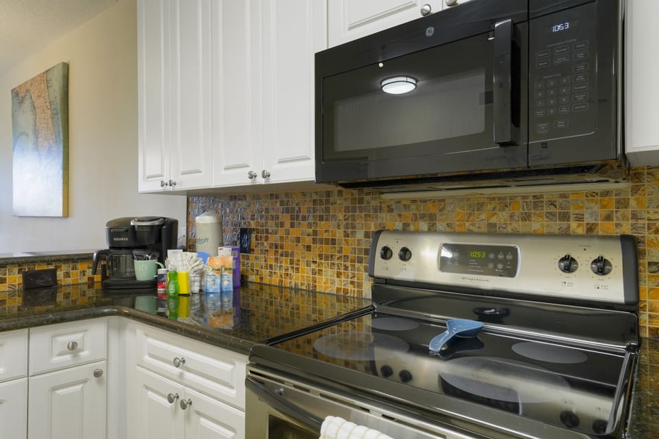 Granite countertops, stainless appliances, and thoughtful coastal details create a welcoming space that feels like your home by the sea.