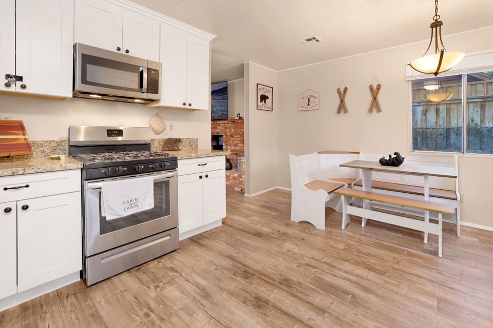 Fully equipped cabin kitchen with ample cabinetry, stove, fridge, microwave, and coffee maker—perfect for cooking meals, morning coffee, and feeling right at home on your stay.