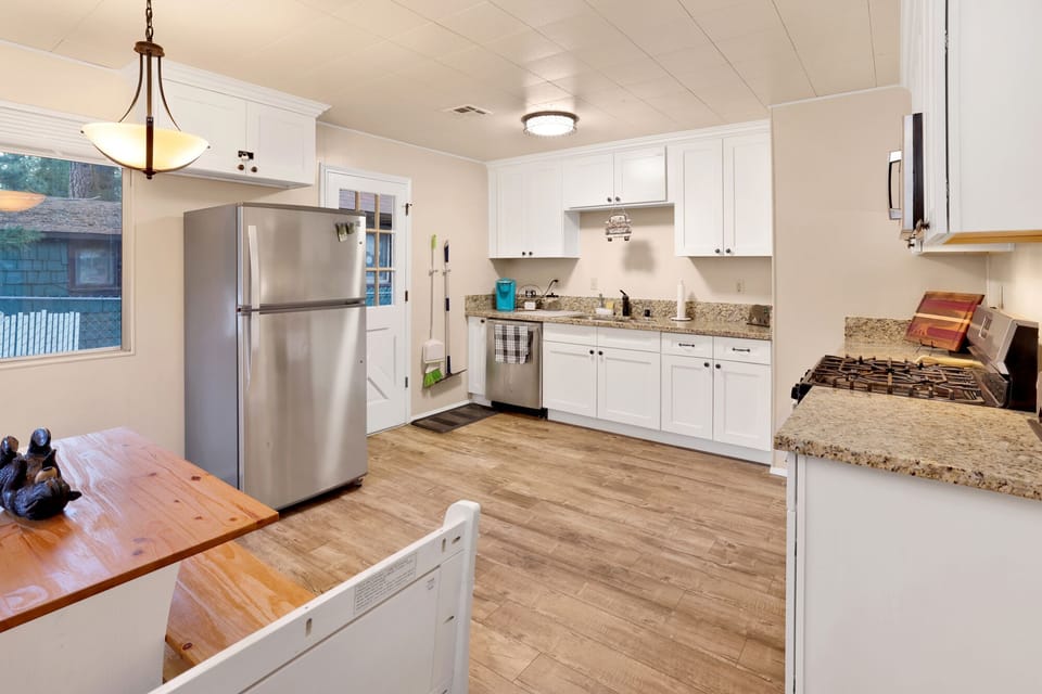 Fully equipped cabin kitchen with ample cabinetry, stove, fridge, microwave, and coffee maker—perfect for cooking meals, morning coffee, and feeling right at home on your stay.