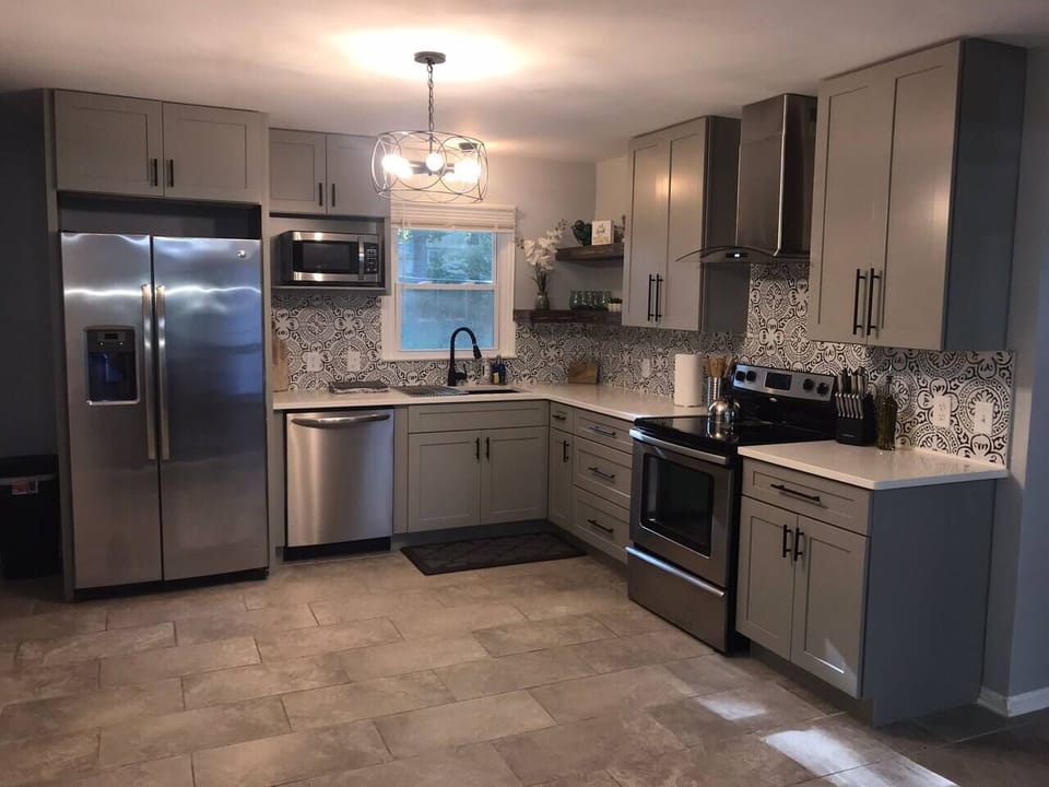 Beautifully renovated kitchen stocked to make a basic meal with everything from pots and pans to dishwear and utensils. 