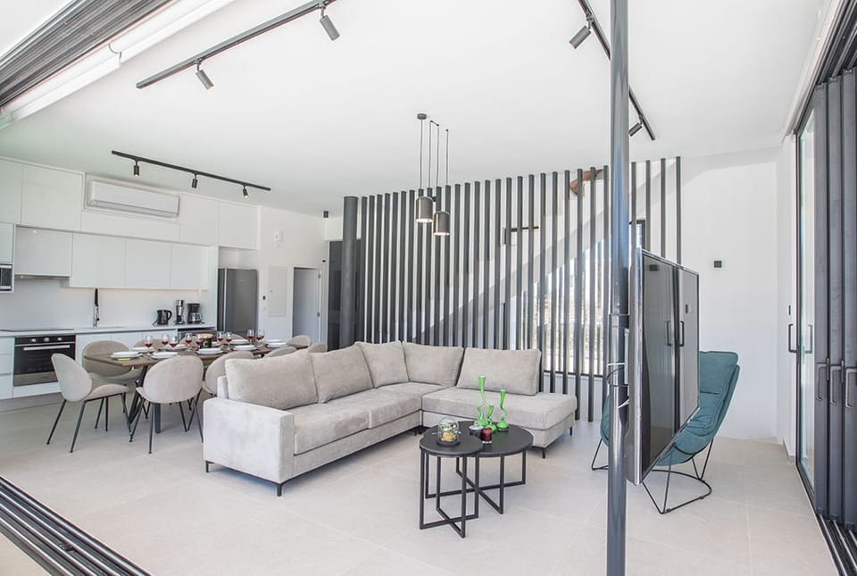 Living room with corner sofa, coffee table and Smart TV