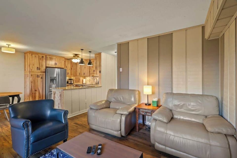 Create a cozy retreat in your living area featuring three comfortable chairs, a Smart TV, an indoor gas fireplace, a door to an outside deck, and a window AC unit.