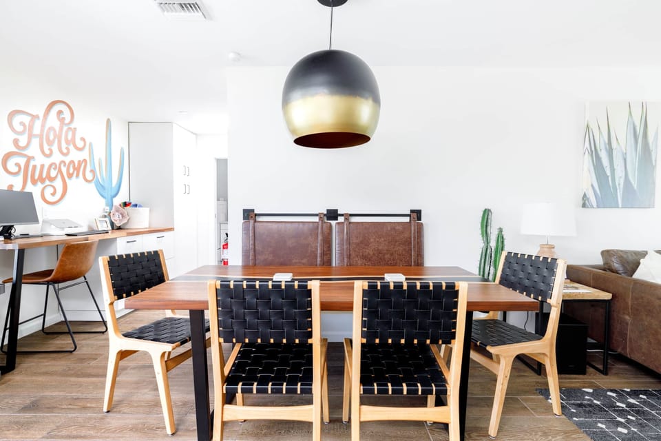 Dining table with seating for six and modern lighting that sets the mood.