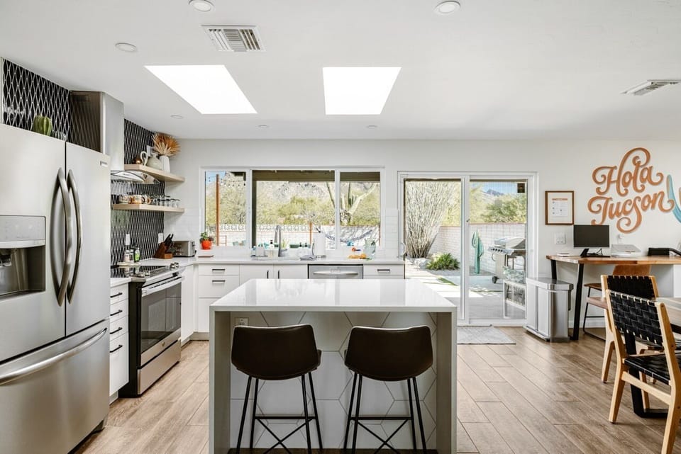 A wall of windows brings Catalina Mountain views and warm natural light inside.