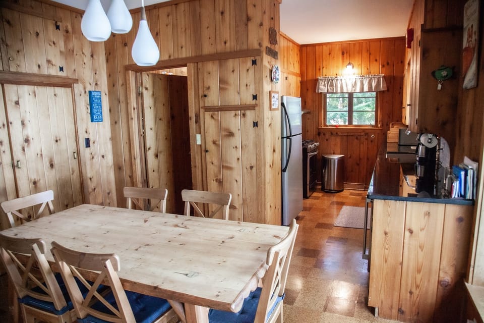 A fully equipped kitchen with stainless-steel appliances and dining area.