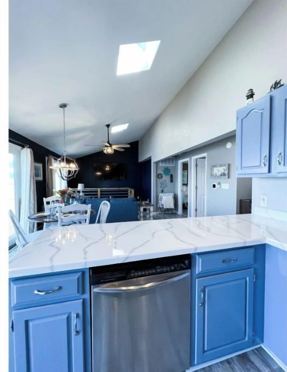 View from kitchen- open floor plan including dining & living room w 70” tv