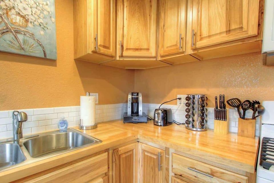 Keurig coffee maker and a variety of hot beverages to choose from. Spice rack for your culinary purposes. Kitchen comes equipped with pots and pans to cook with and other utensils you may need. Fridge is stocked with condiments and brita water filter