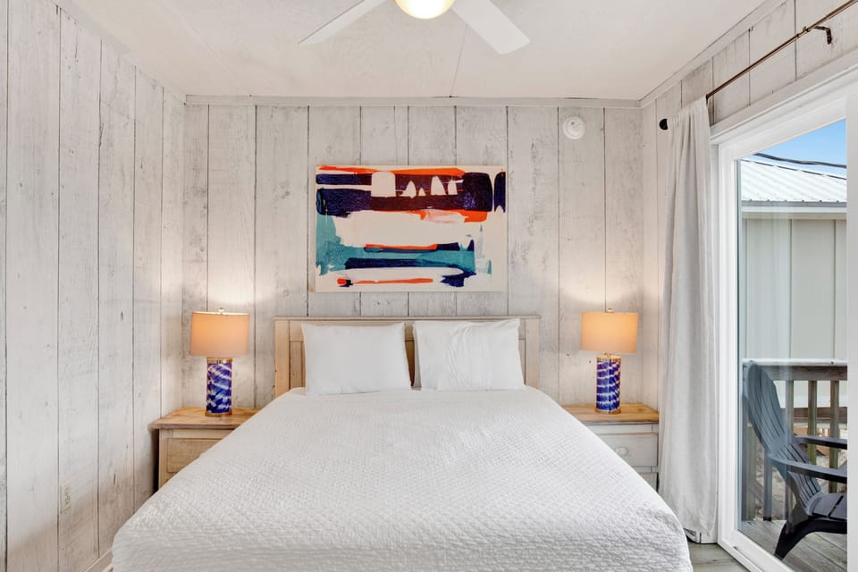 Guest bedroom 2 features a queen bed and shares the bathroom in the hall