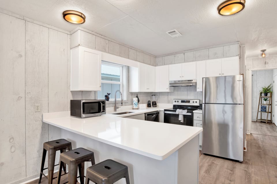 Renovated kitchen features new cabinets and granite counter tops