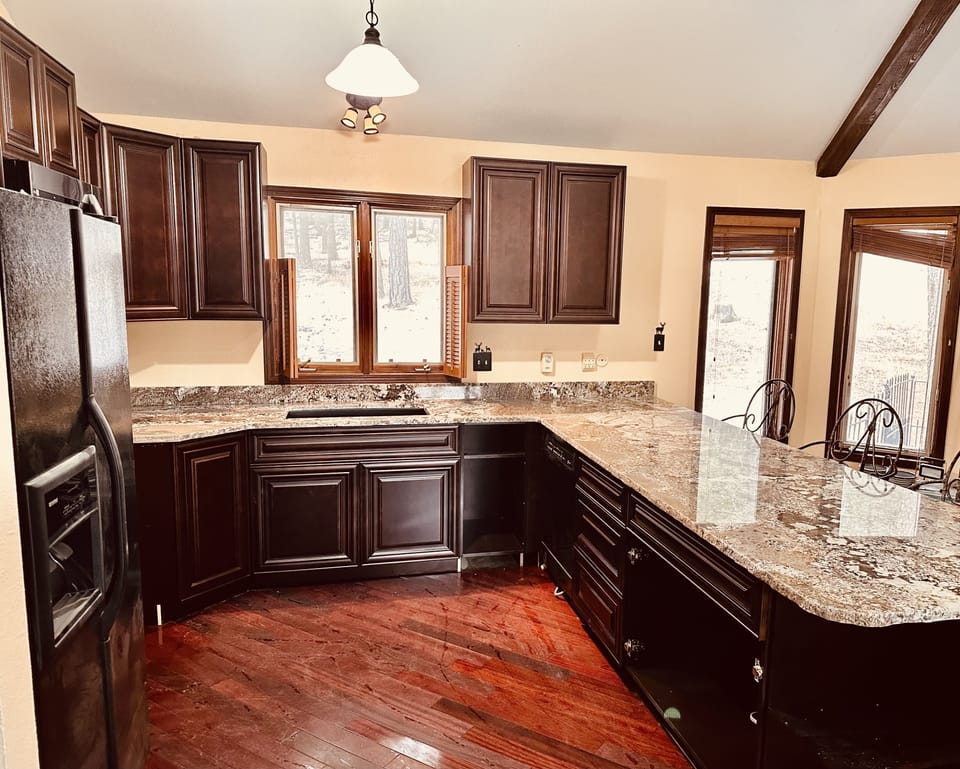 Fully stocked kitchen with a huge granite countertop and bar seating for 5.