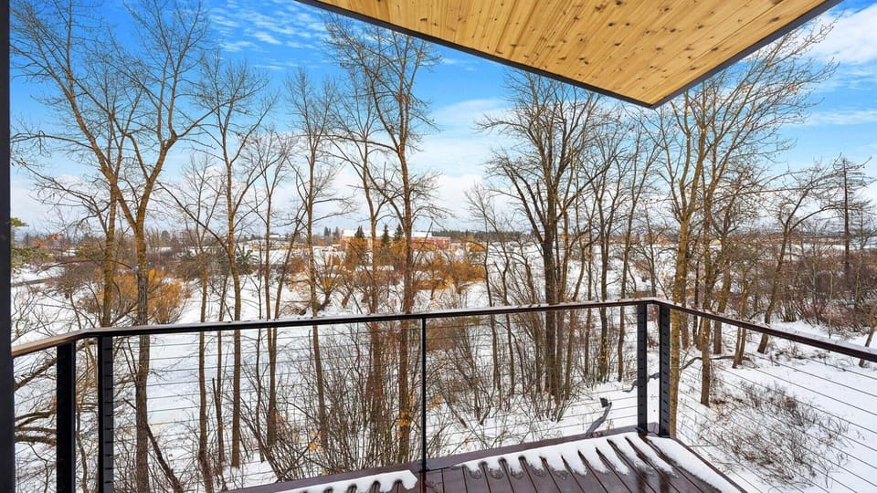 The view from the balcony overlooking the Whitefish River and the private access with a dock.