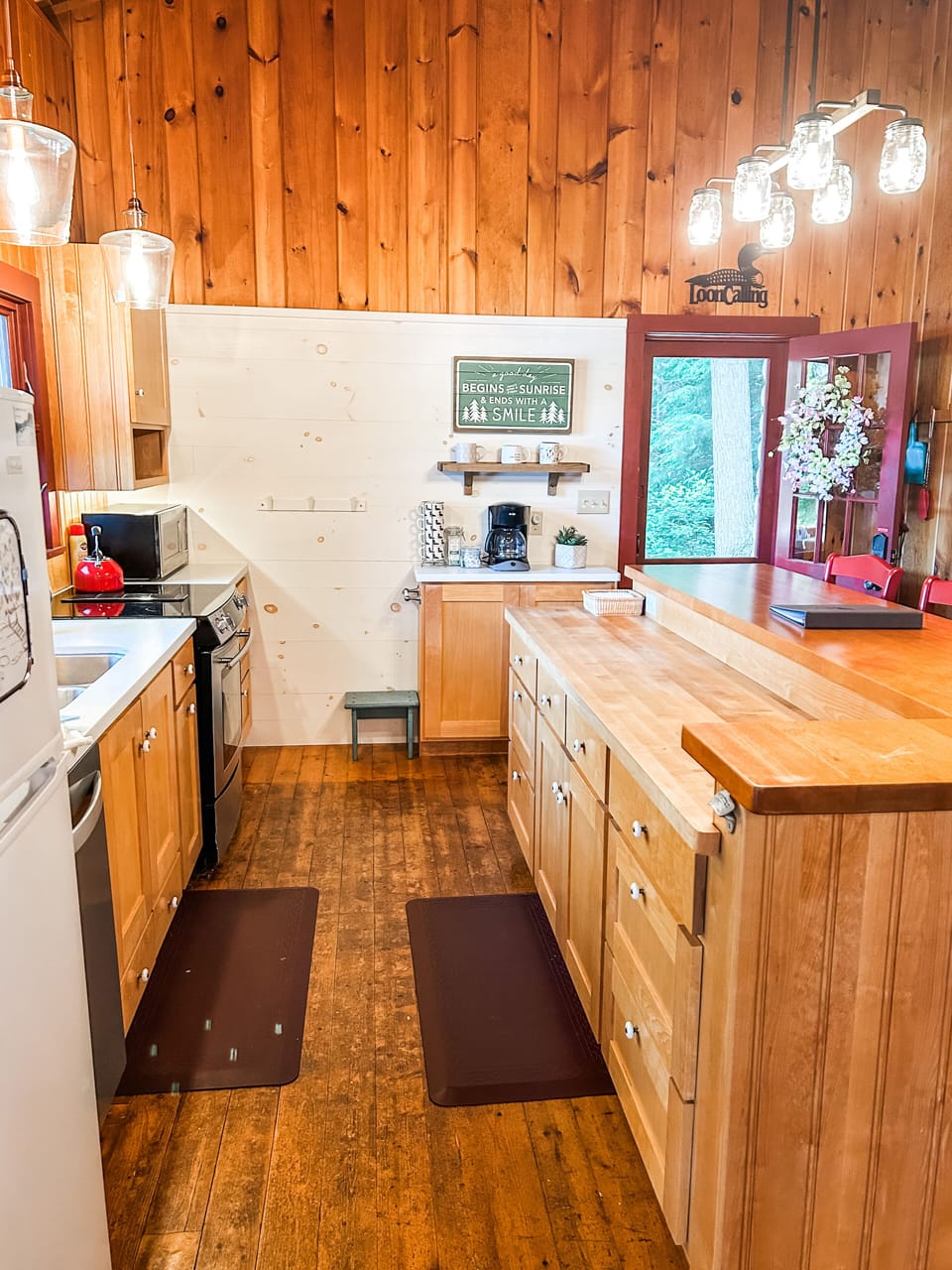 Galley kitchen w/windows that overlook the lake. Breakfast bar to the right.