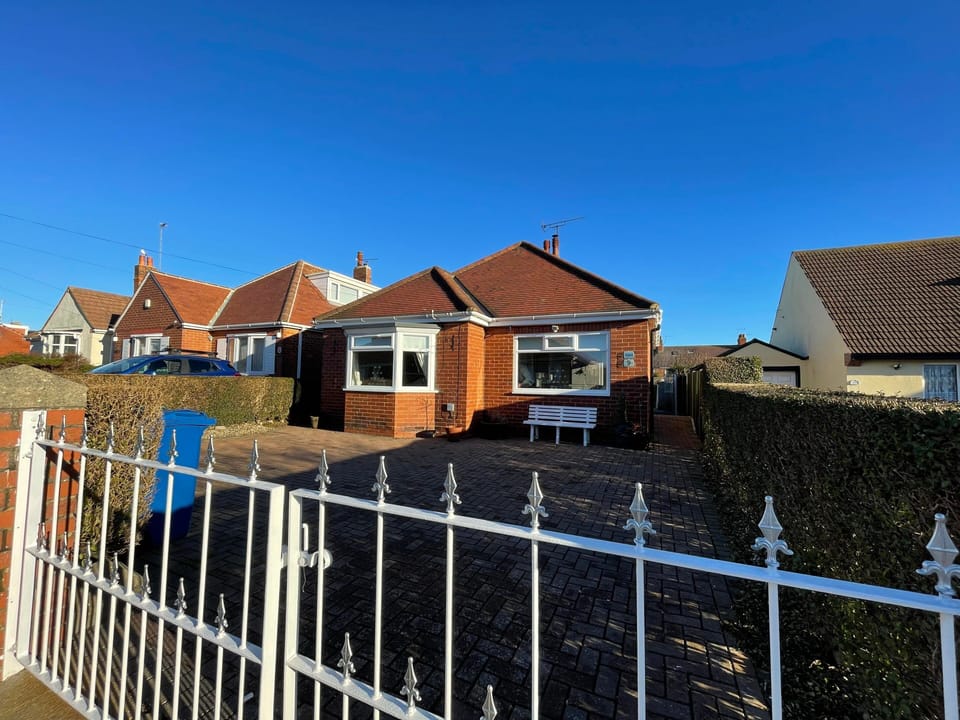 Detached bungalow, spacious driveway, parking up to 3 cars with gates closed.