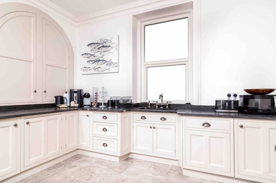 Kitchen with ample food storage and coffee maker.