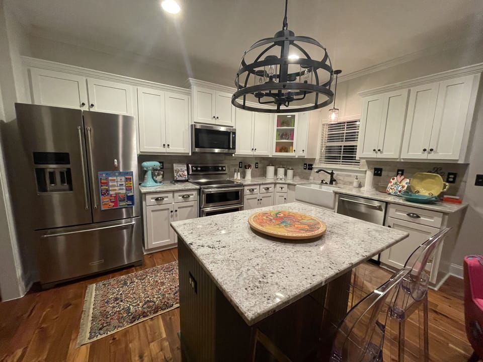Kitchen: Glass top stove, double oven, microwave, dishwasher, island seating
