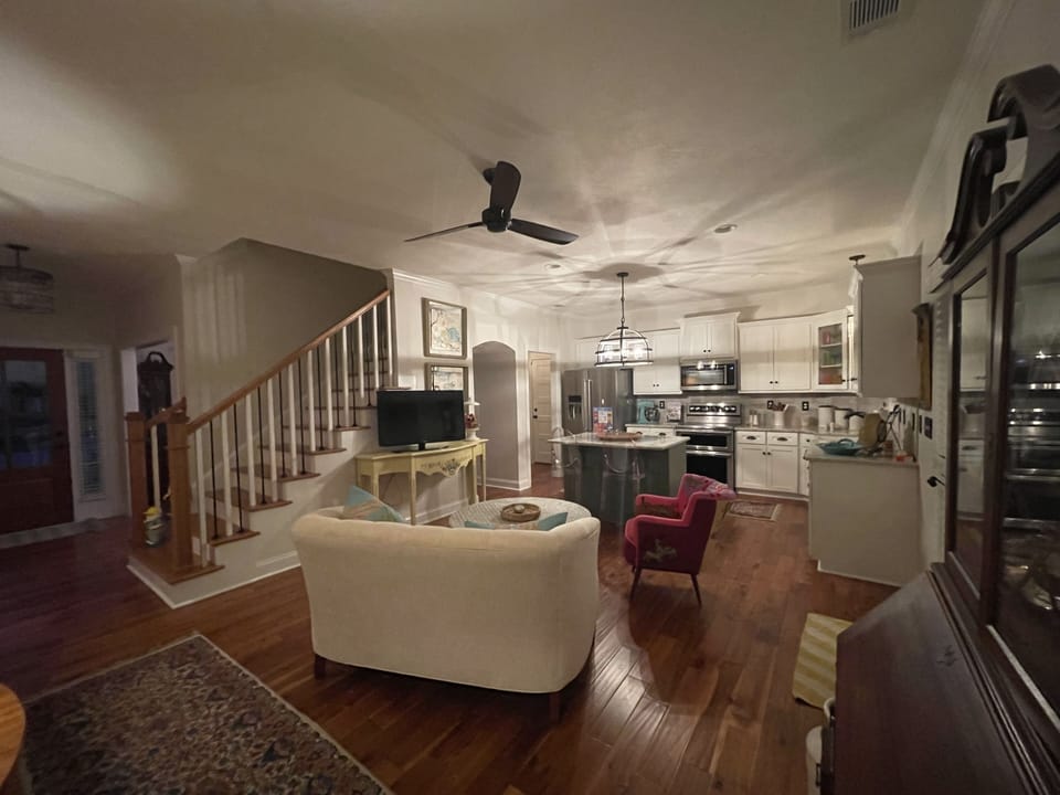 Open floor plan: kitchen and den area with door leading to screen porch
