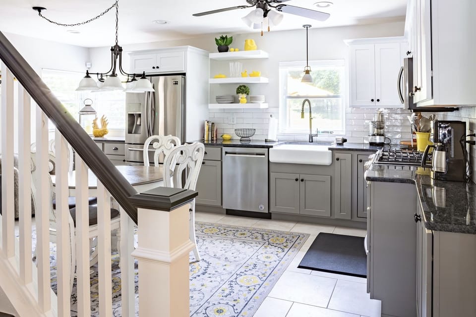 Open shelving, farm sink, updated colors all make this a cozy hangout for all.