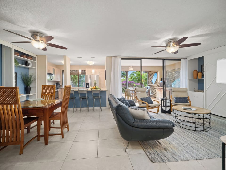 Open concept kitchen-dining-living room with large doors out to the lanai.