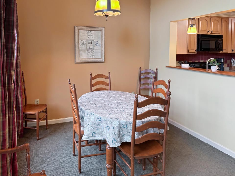 Cozy dining area with warm lighting and open kitchen access