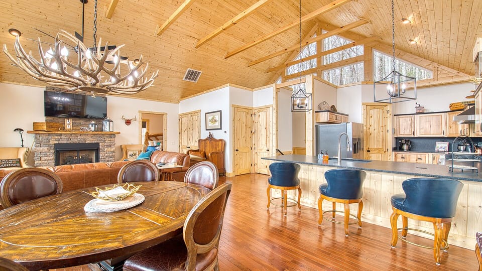 The open concept kitchen/dining room/living room with vaulted ceilings.