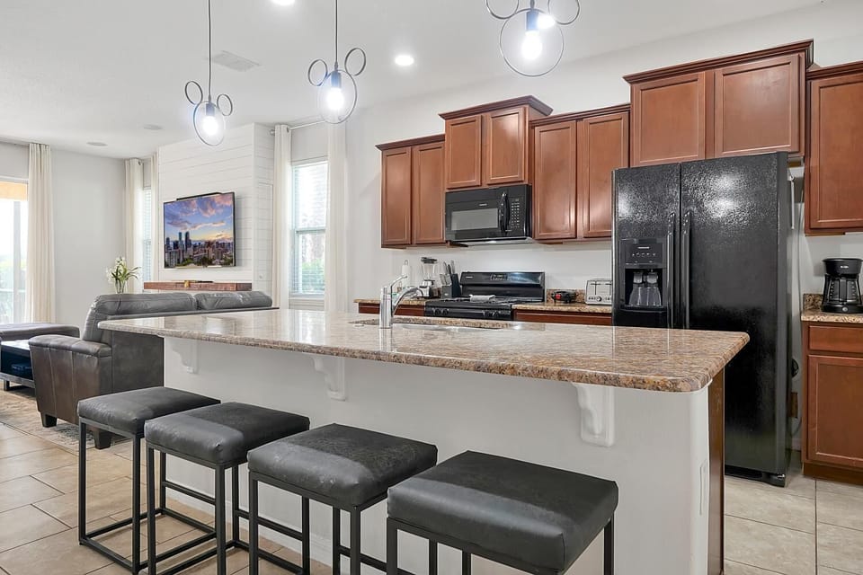 Open kitchen with island and breakfast bar to seat 4