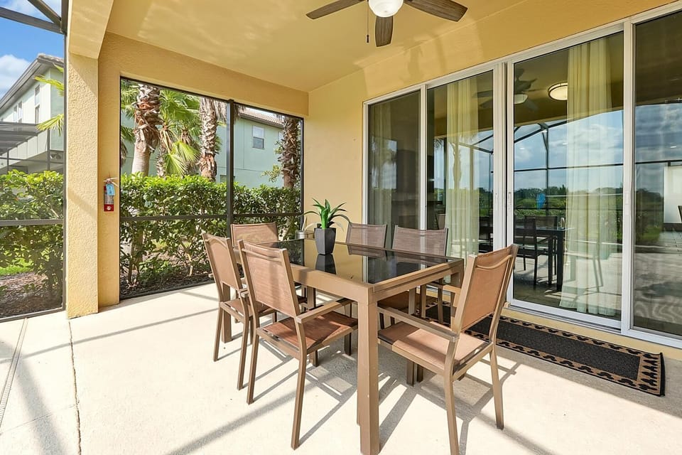 Outdoor dining table with 6 chairs, ceiling fan and light, and Mickey rug