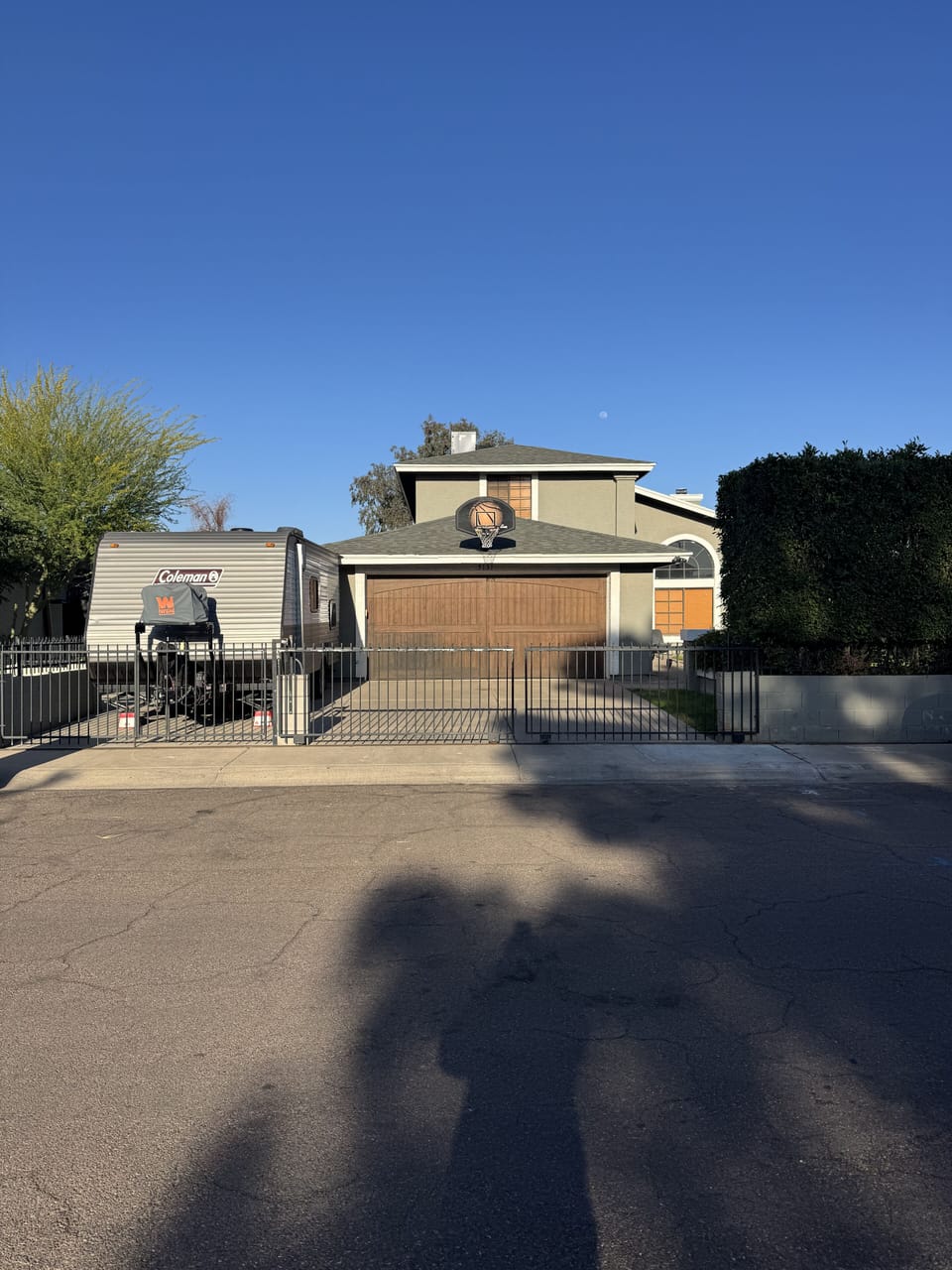 Large 3 car driveway and basketball hoop at front of home.