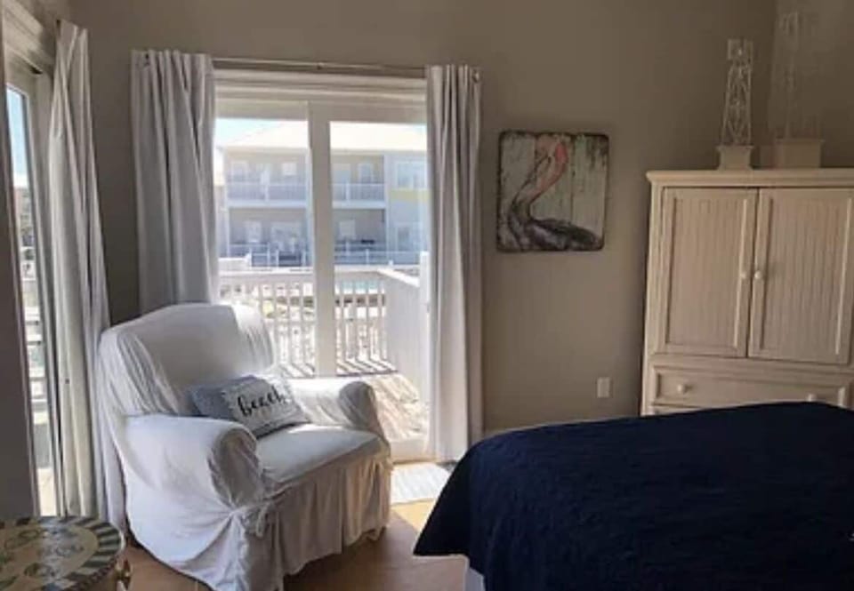 Master on main level with open access to deck overlooking the pool and Gulf view