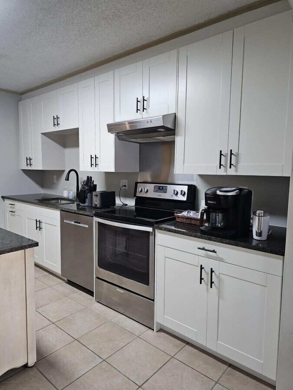 Fully equipped kitchen with stainless steel appliances and modern cabinetry.