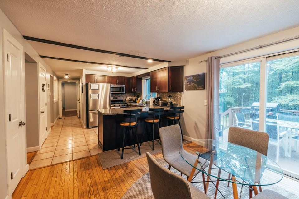 Kitchen area table, bar, walk out back deck