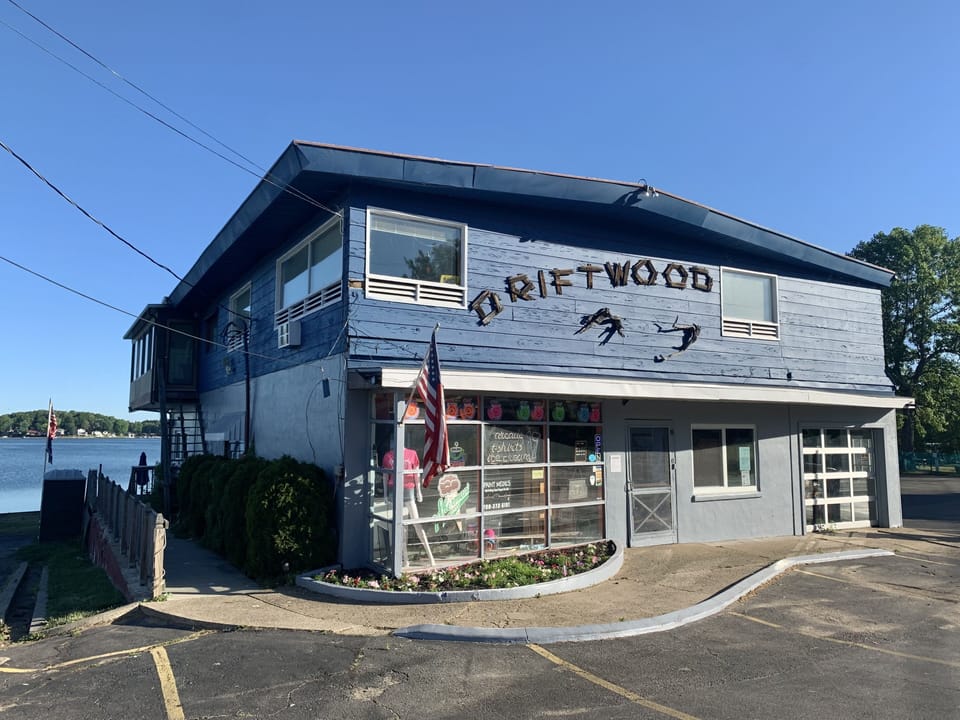 The entrance to the Sunset Suite is on the left side of Driftwood Summer Shop. 