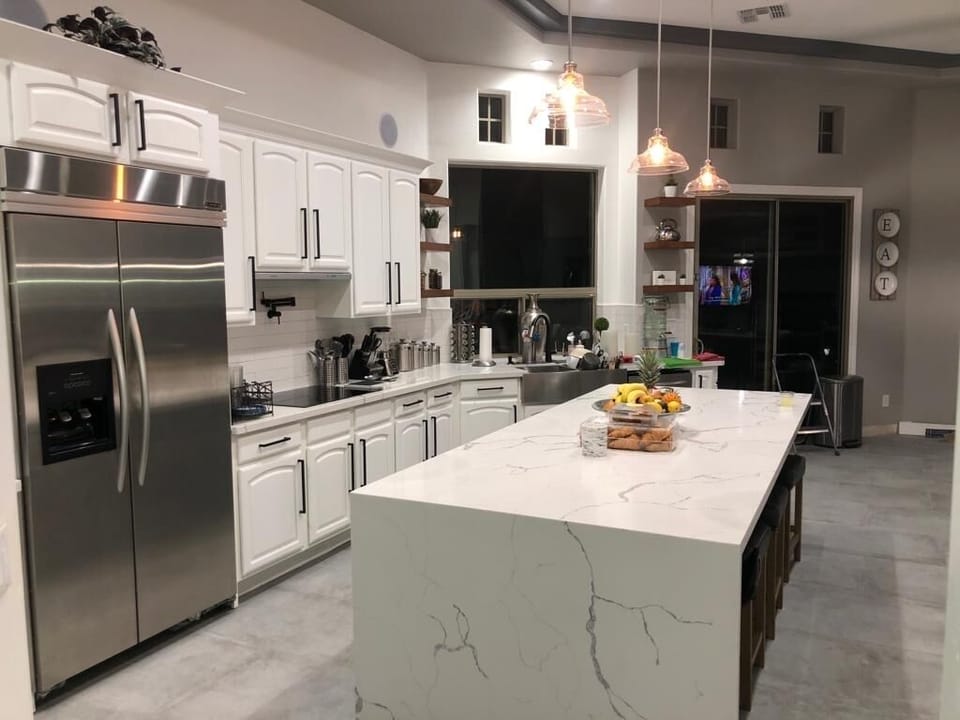 Huge kitchen with quartz countertop with water fall stone