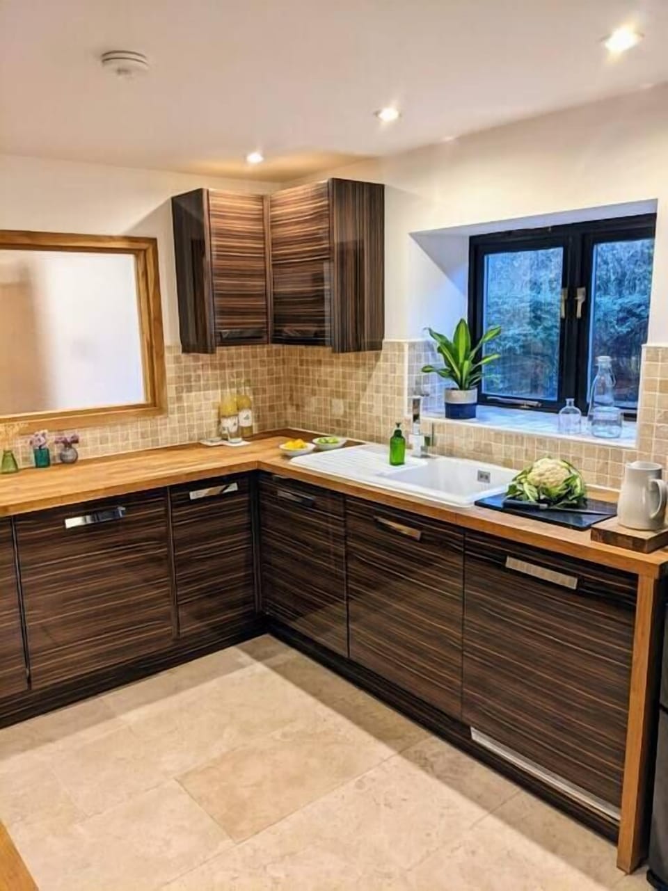 The kitchen has a washing machine, a dishwasher and a dryer.