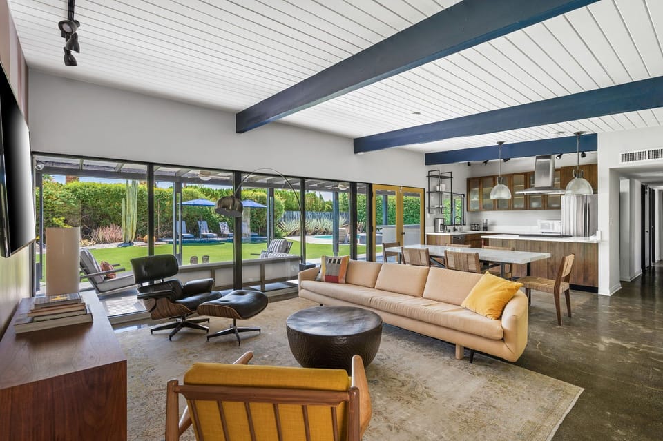 Open concept with exposed beams and stylish furnishings