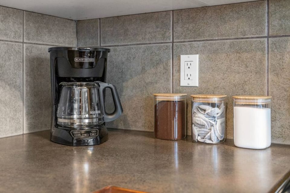 Full kitchen with a drip coffee machine, ground coffee, tea, sugar and basic condiments (ketchup, mustard and relish.)