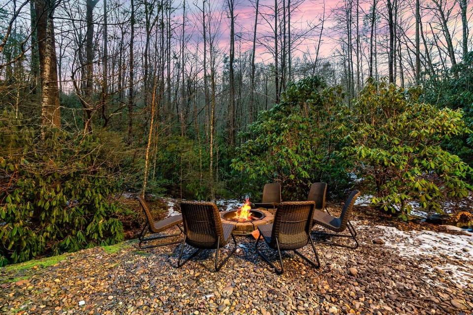 Smoky Mountain fire pit surrounded by trees — perfect for s’mores