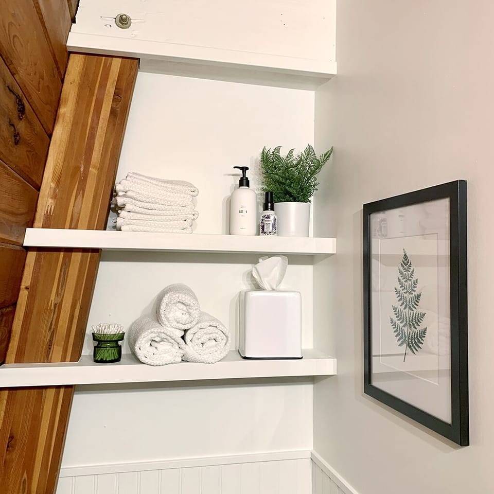Bathroom shelving with extra supplies for your convenience.