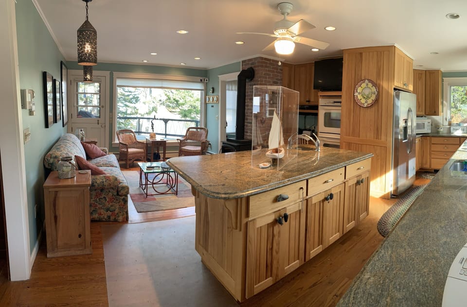 Gourmet kitchen; family room w/wood stove, and large deck overlooking sand beach