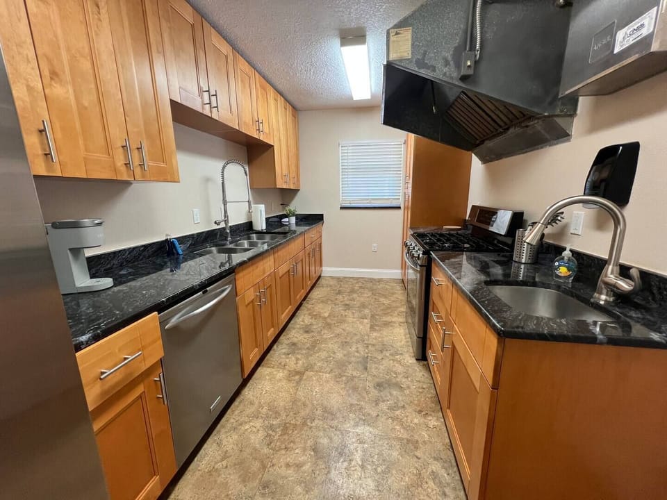 Full kitchen with stove, microwave, dishwasher, Keurig coffee maker and toaster.