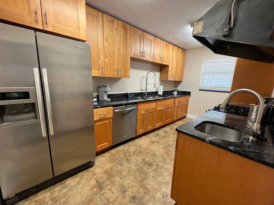 Full kitchen with stove, microwave, dishwasher, Keurig coffee maker and toaster.