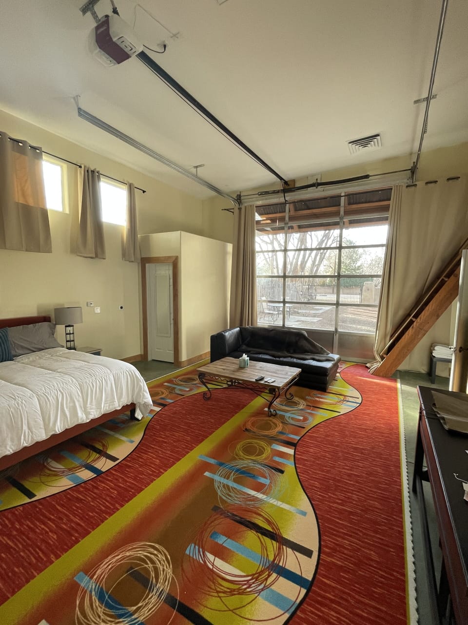 Converted RV garage offers spacious feel, glass door opens, privacy drapes