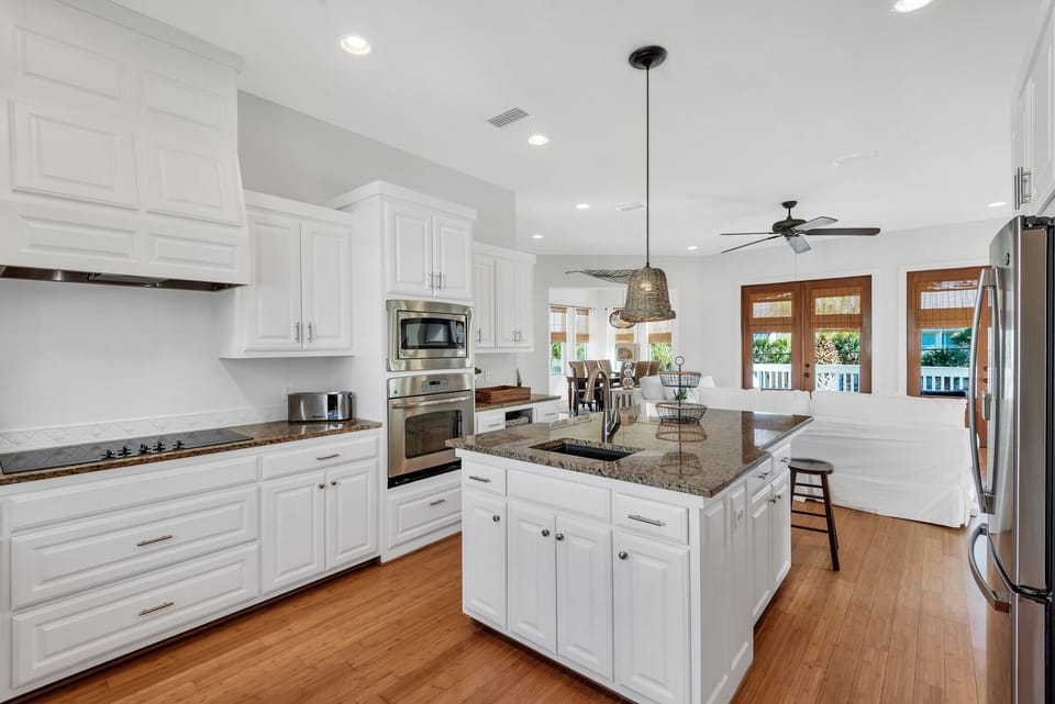 Oversized kitchen with gorgeous granite, spacious cabinets, stainless appliances, additional wet bar and island with extra seating (second level)